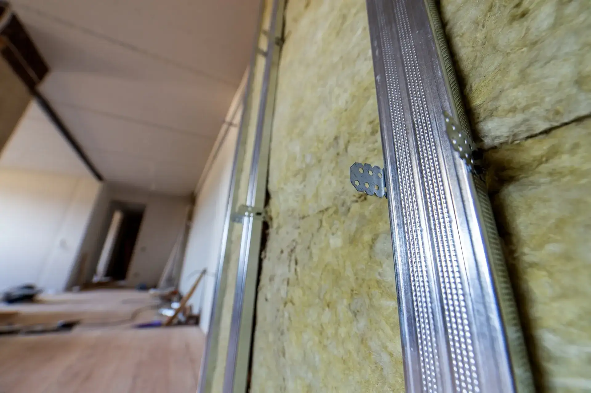 Wall renovation with acoustic insulation materials being installed